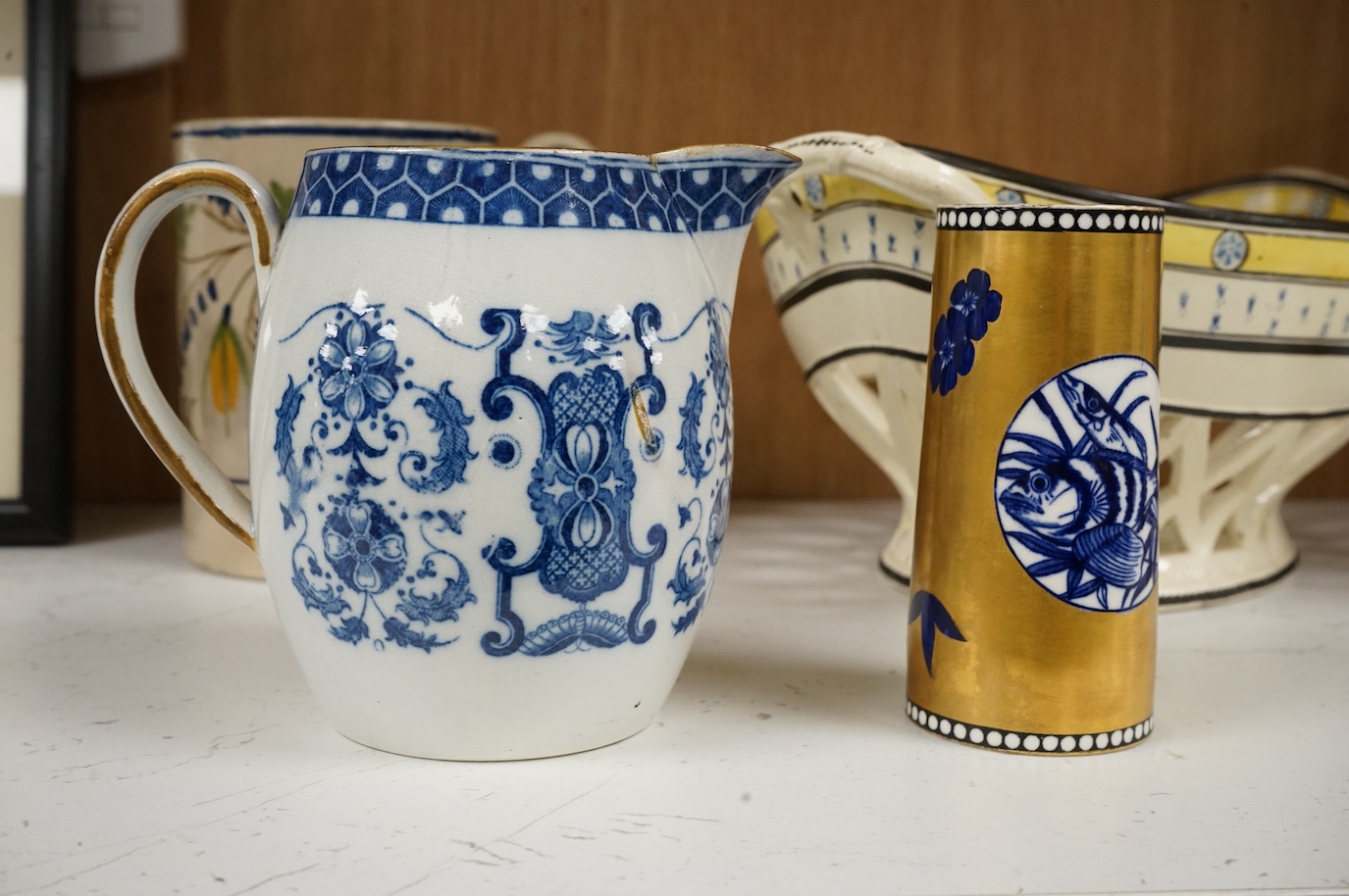 A George III creamware basket, a pearlware mug and jug, a Coalport spill vase (four), basket 26.5cm handle to handle.